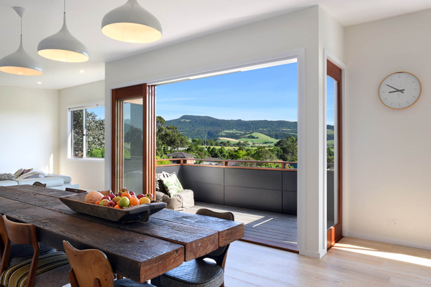 A contemporary kitchen in Gerringong, NSW, featuring expansive windows that flood the space with natural light, designed by Lime Building Group.